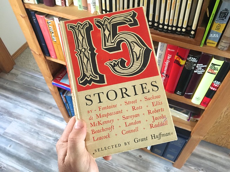 A hand holding up a book with the title "15 Stories"