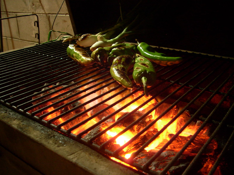 Some chile peppers over a very hot grill.