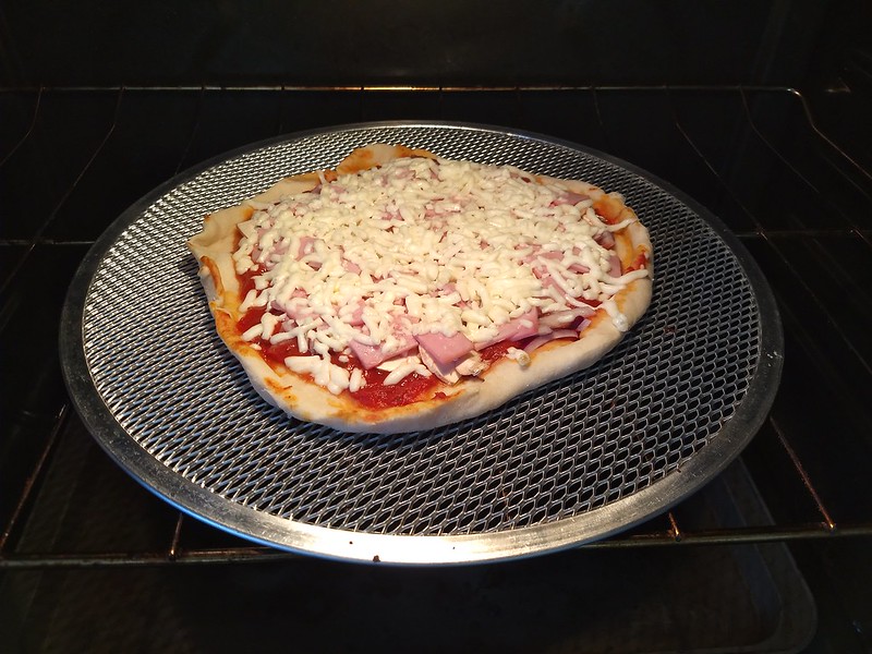 Pizza on a New Pizza Pan. We got a new pan with a grill base that seems to get a crisper crust. I did half size crusts for this batch which turned out nicely.