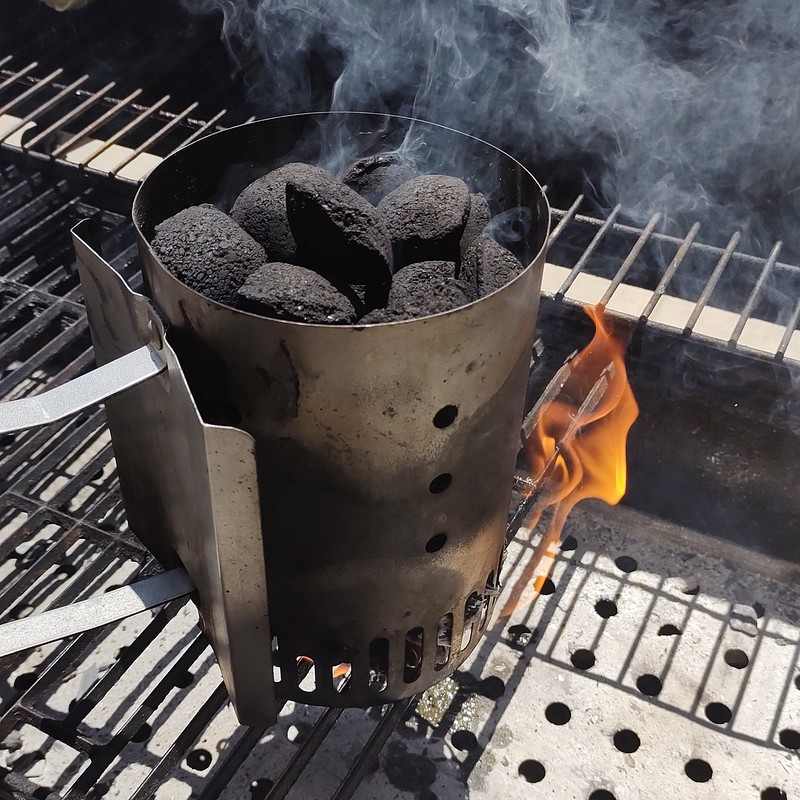 My charcoal chimney starter, just lit and sitting on my grill.