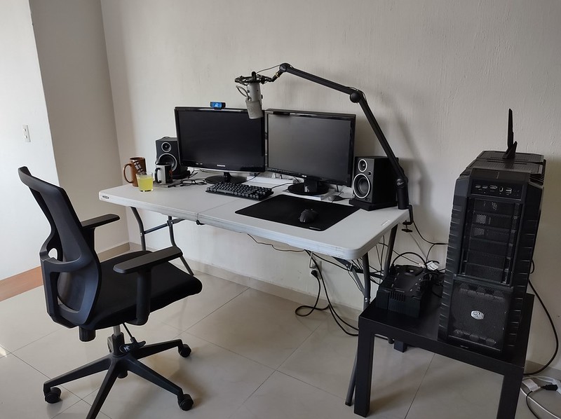 Desktop computer with office chair setup on a folding table.