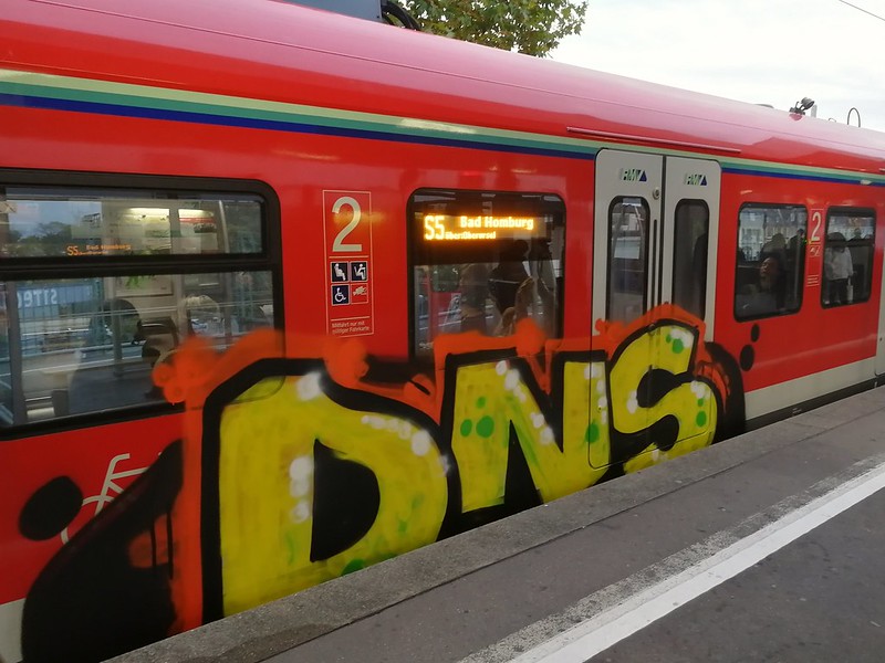 Train car in Germany with DNS painted in graffiti on the side.