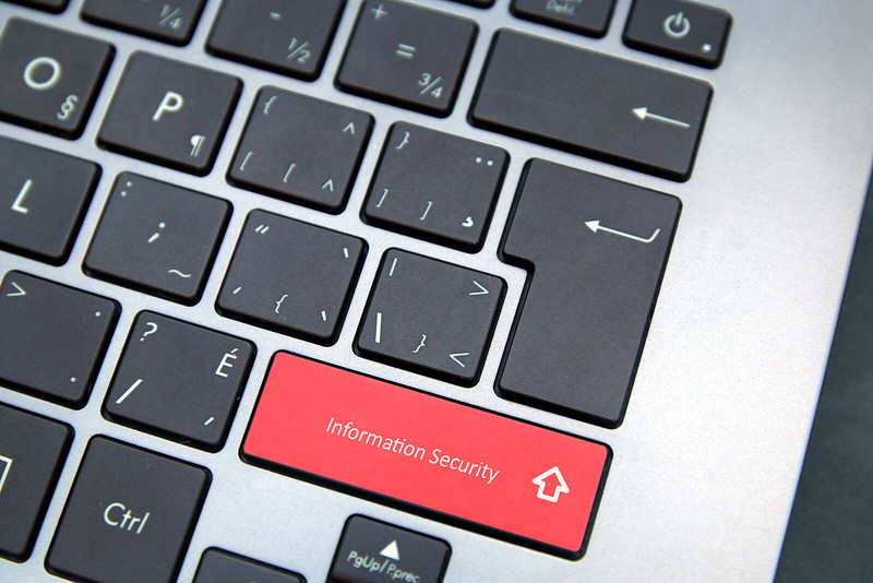Close up show of the right side of a laptop keyboard. The right shift key is red (others are standard black) and labeled "Information Security".