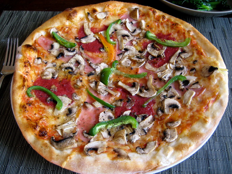 Image of a homemade pizza with mushrooms and green peppers clearly visible.
