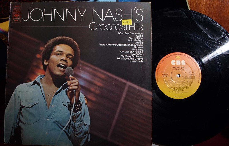 Picture of the album cover with the album exposed and visible with the label of Johnny Nash's Greatest Hits. Song titles visible and a picture of Johnny singing in a denim shirt.