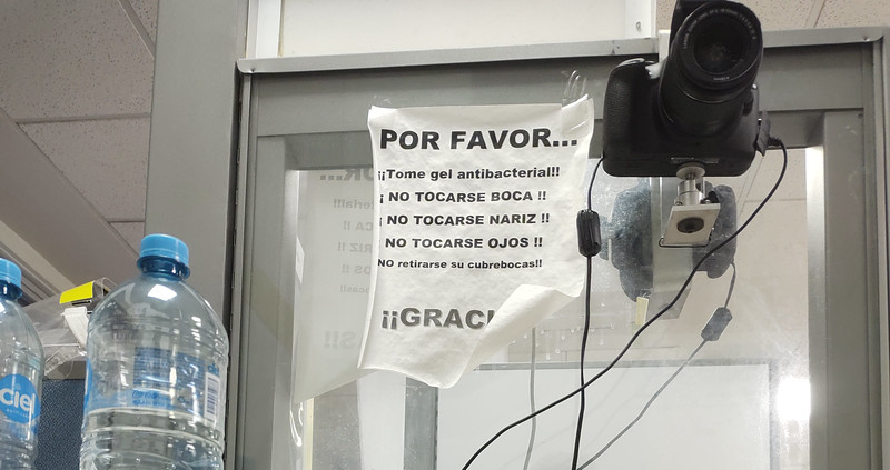 Sign in Spanish beside the camera for driver's license picture. Clearly stating to not remove your mask (but was asked for the photo) and to use anti-bacterial gel (there was none around).